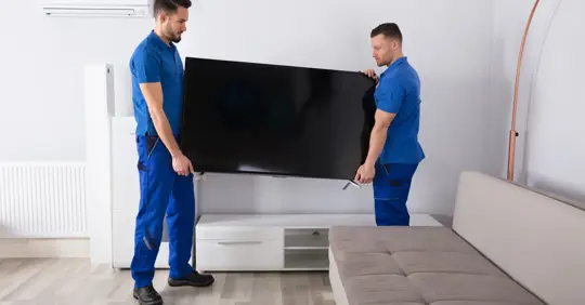 Movers carrying a TV